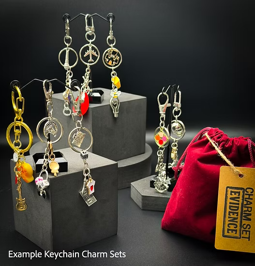 Keychain charm sets on display with a red drawstring bag labeled 'Charm Set Evidence'.