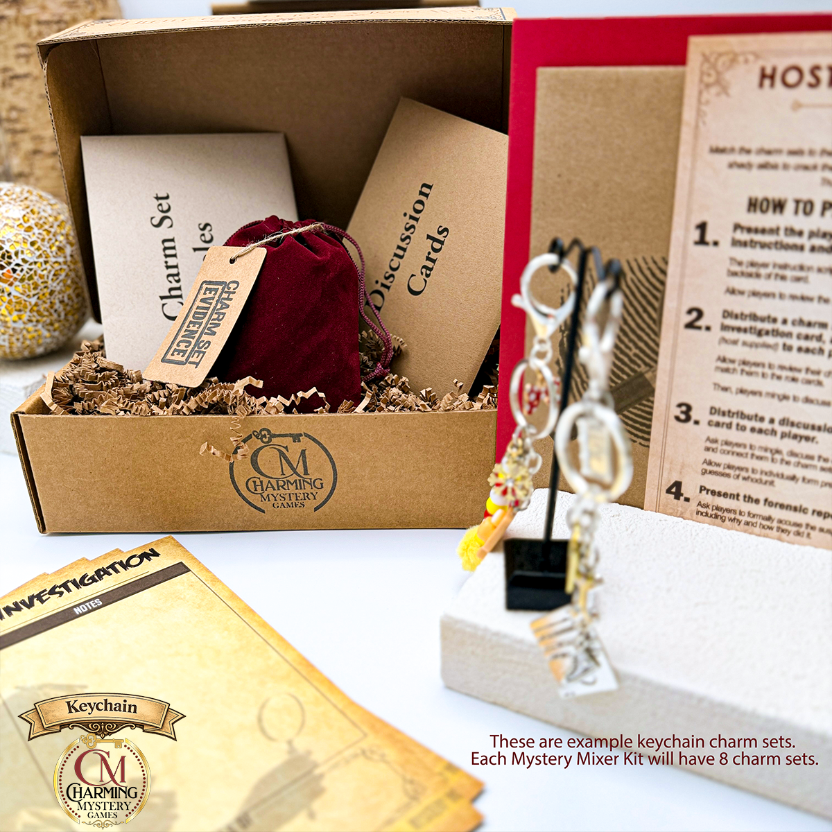 The packaging for the Butler Didn't Do It murder mystery party game. There are two keychain examples shown, with cards and a velveteen pouch in the retail box. 