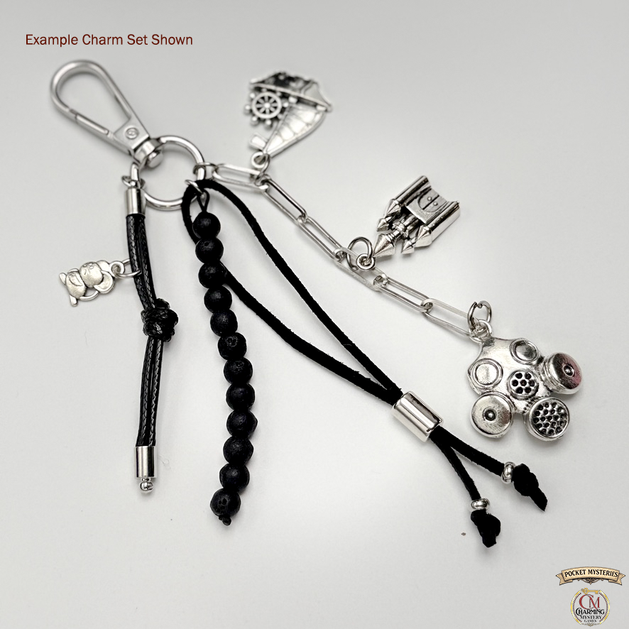 Keychain with black beads and silver charms on a white background