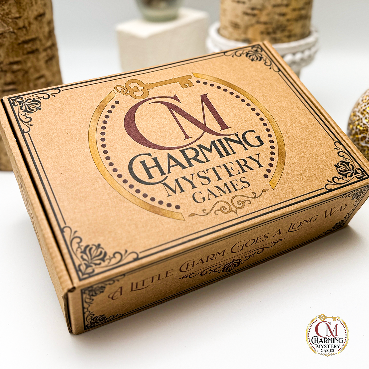 A box for a mystery party game played with charm sets. It has the Charming Mystery Party Games logo on it, and it is kraft color. 