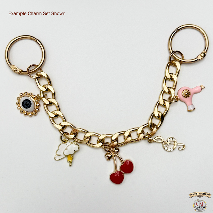 Gold charm bracelet with various charms on a white background