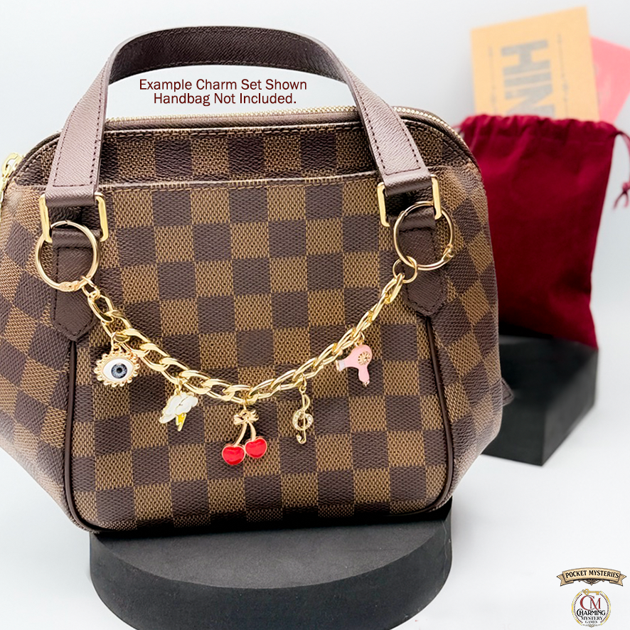 Checkered handbag with gold chain and charms on a white background