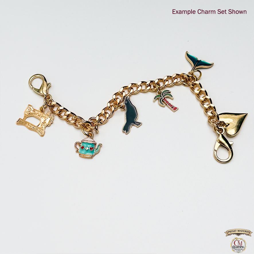 Gold charm bracelet with various charms on a white background