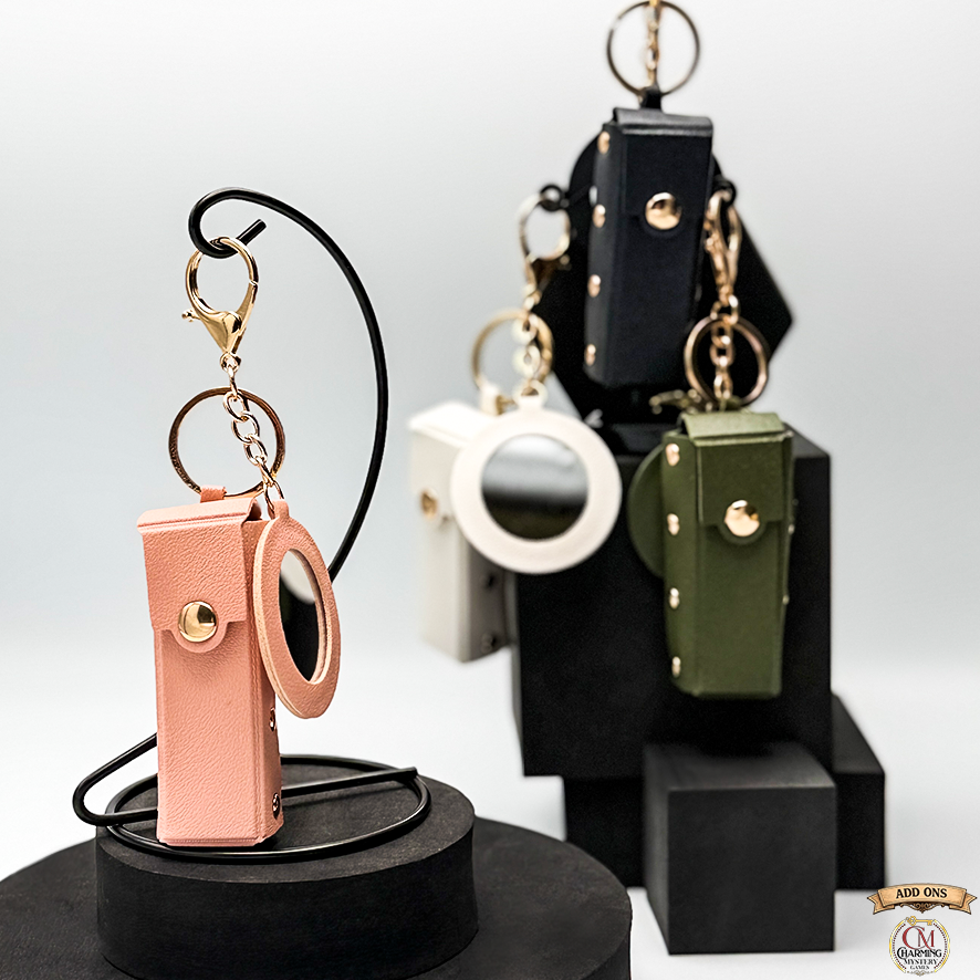 Keychains on a black stand with a white background