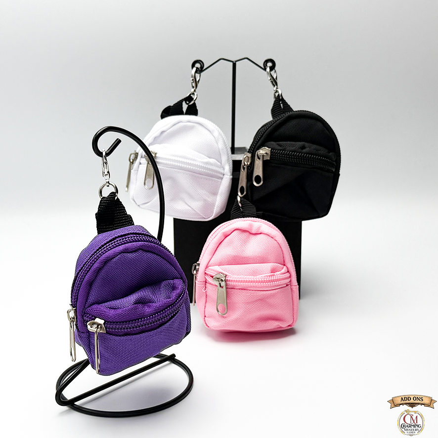Set of small bags in purple, pink, black, and white on a stand with a visible brand logo.
