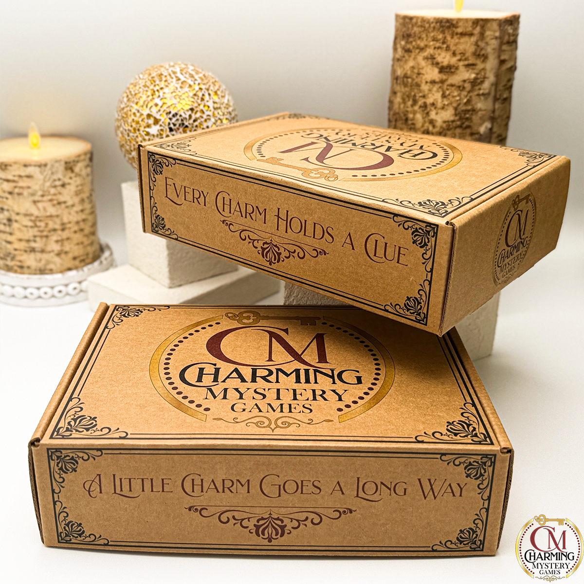 Two kraft brown boxes with charming mystery games logo