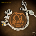 Silver charm bracelet with various charms on a brown background with 'Charming Mystery Games' branding.