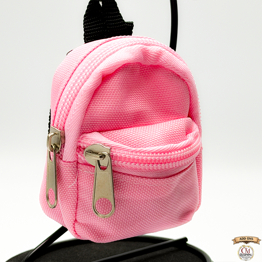 Pink mini backpack with a visible brand logo on a white background