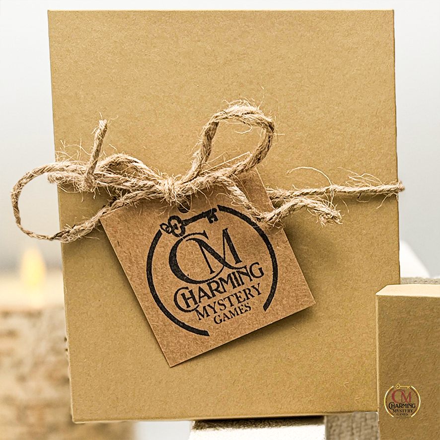 A brown kraft jewelry box with a jute bow and Charming Mystery Games tag on it. 