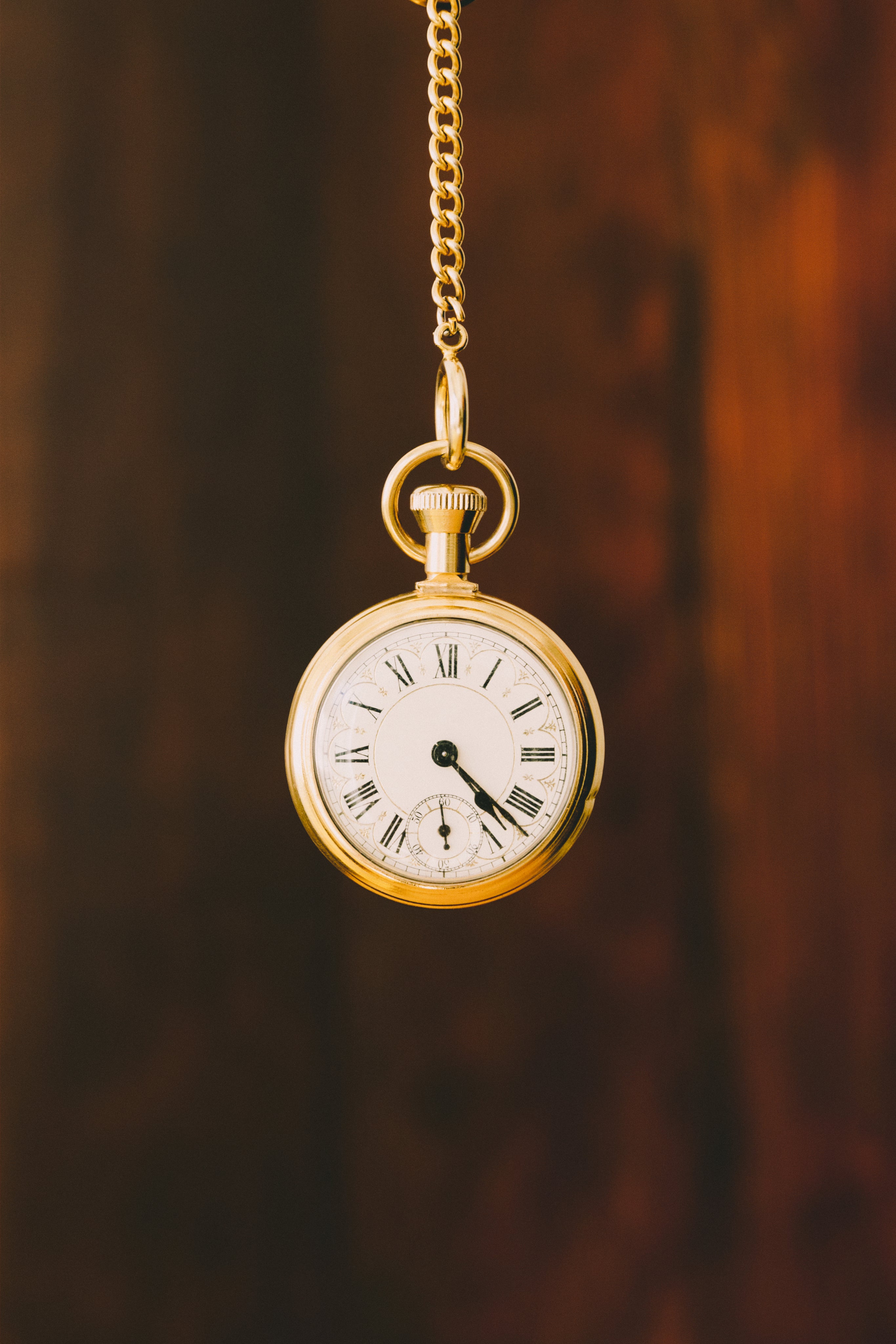 A mysterious pocket watch hanging from a gold chain. 
