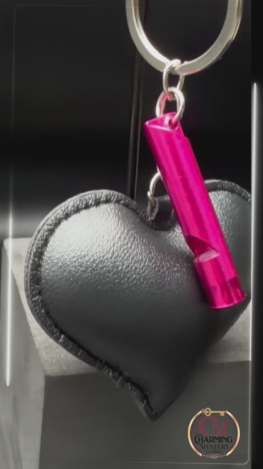 A video of a black heart keychain. 