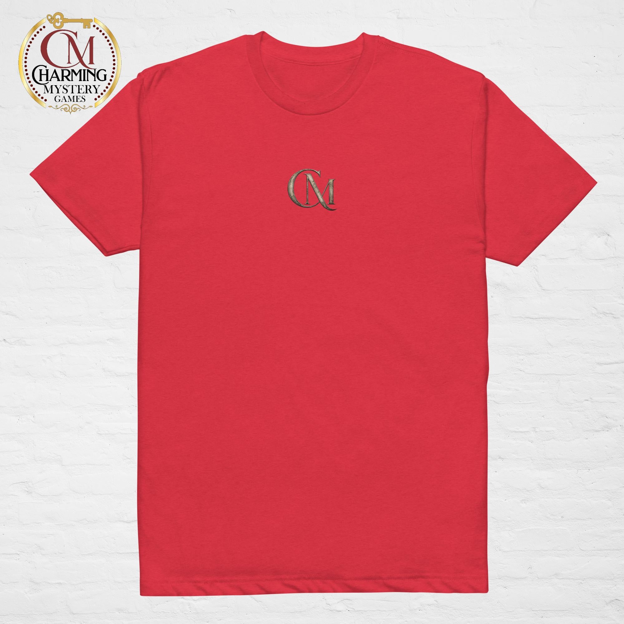 Product mockup of a red tee shirt that has a CM logo on it for Charming Mystery Games. 